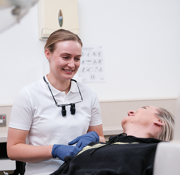 Aesthetic Dentist Megan explaining a procedure to a relaxed patient at West Dental